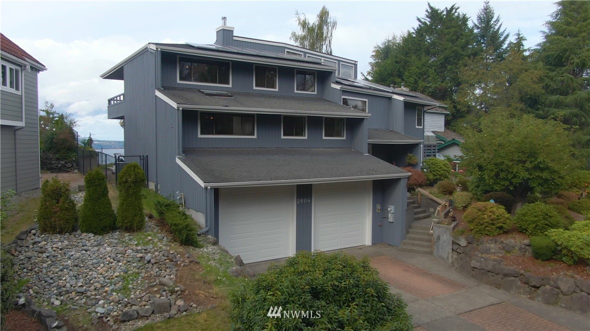 2604 Madrona Point Lane Steilacoom, WA 98388 - Photo 3 of 25 a front view of a house with a yard garage and outdoor seating