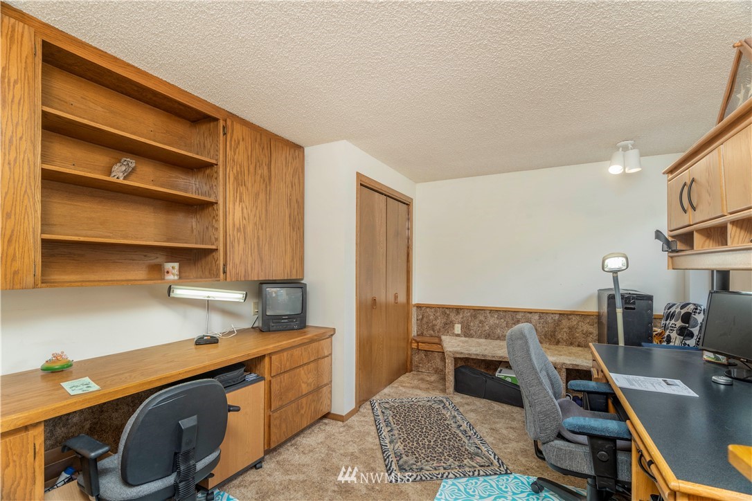 2604 Madrona Point Lane Steilacoom, WA 98388 - Photo 21 of 25 a view of a kitchen with fridge and workspace