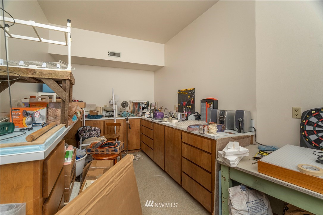 2604 Madrona Point Lane Steilacoom, WA 98388 - Photo 22 of 25 a room with wooden cabinets and a sink