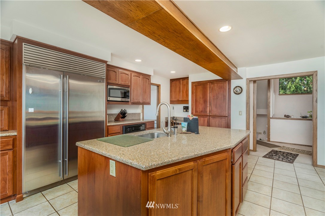 2604 Madrona Point Lane Steilacoom, WA 98388 - Photo 5 of 25 a kitchen with stainless steel appliances granite countertop a refrigerator a sink and a stove