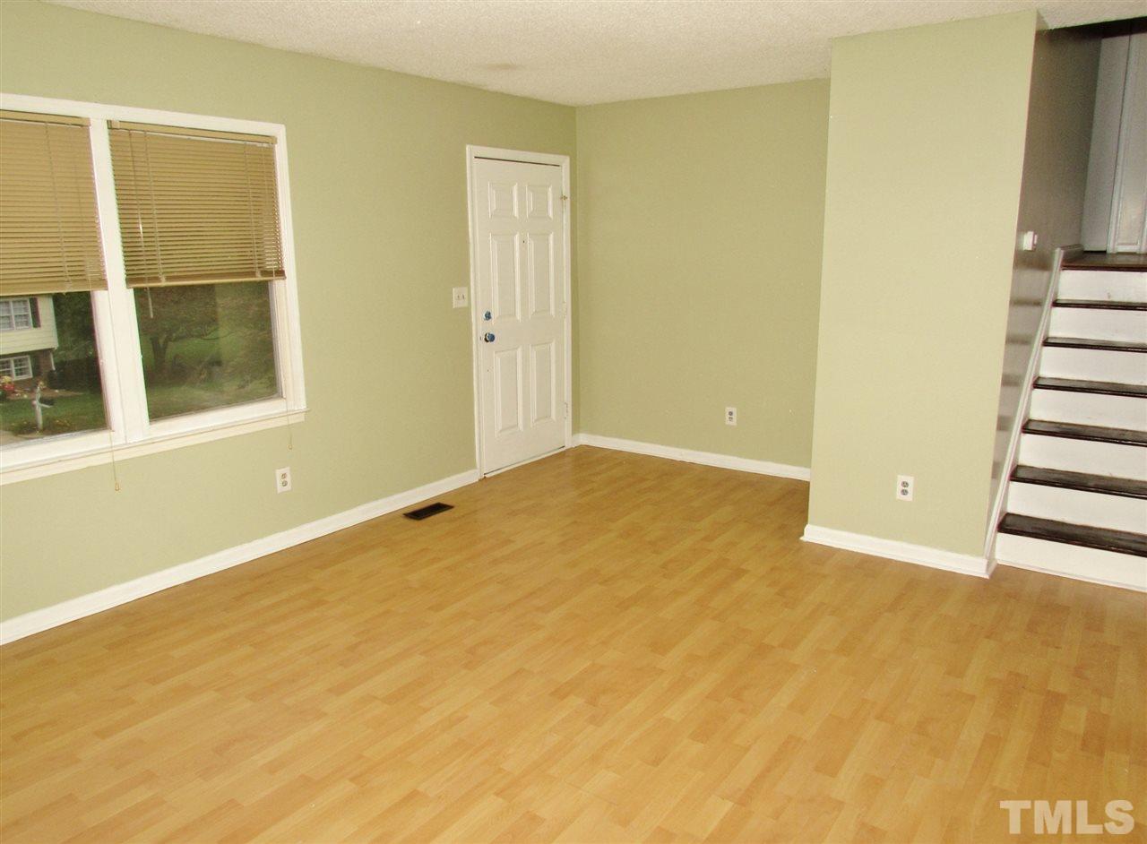 7813 Nugget Lane Raleigh, NC 27615 - Photo 2 of 25 a view of an empty room with wooden floor and windows