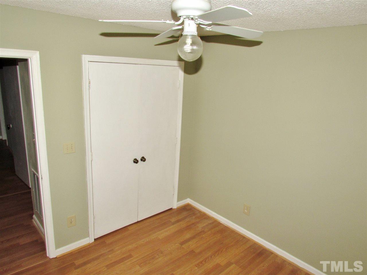 7813 Nugget Lane Raleigh, NC 27615 - Photo 14 of 25 a view of a small space with wooden floor and a ceiling fan