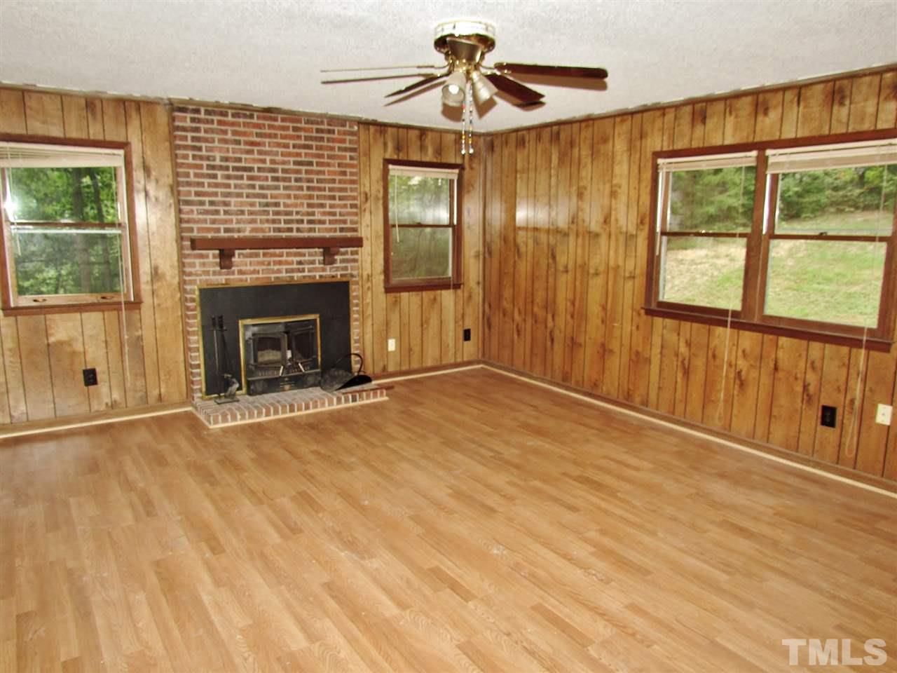 7813 Nugget Lane Raleigh, NC 27615 - Photo 15 of 25 a view of empty room with fireplace and fan
