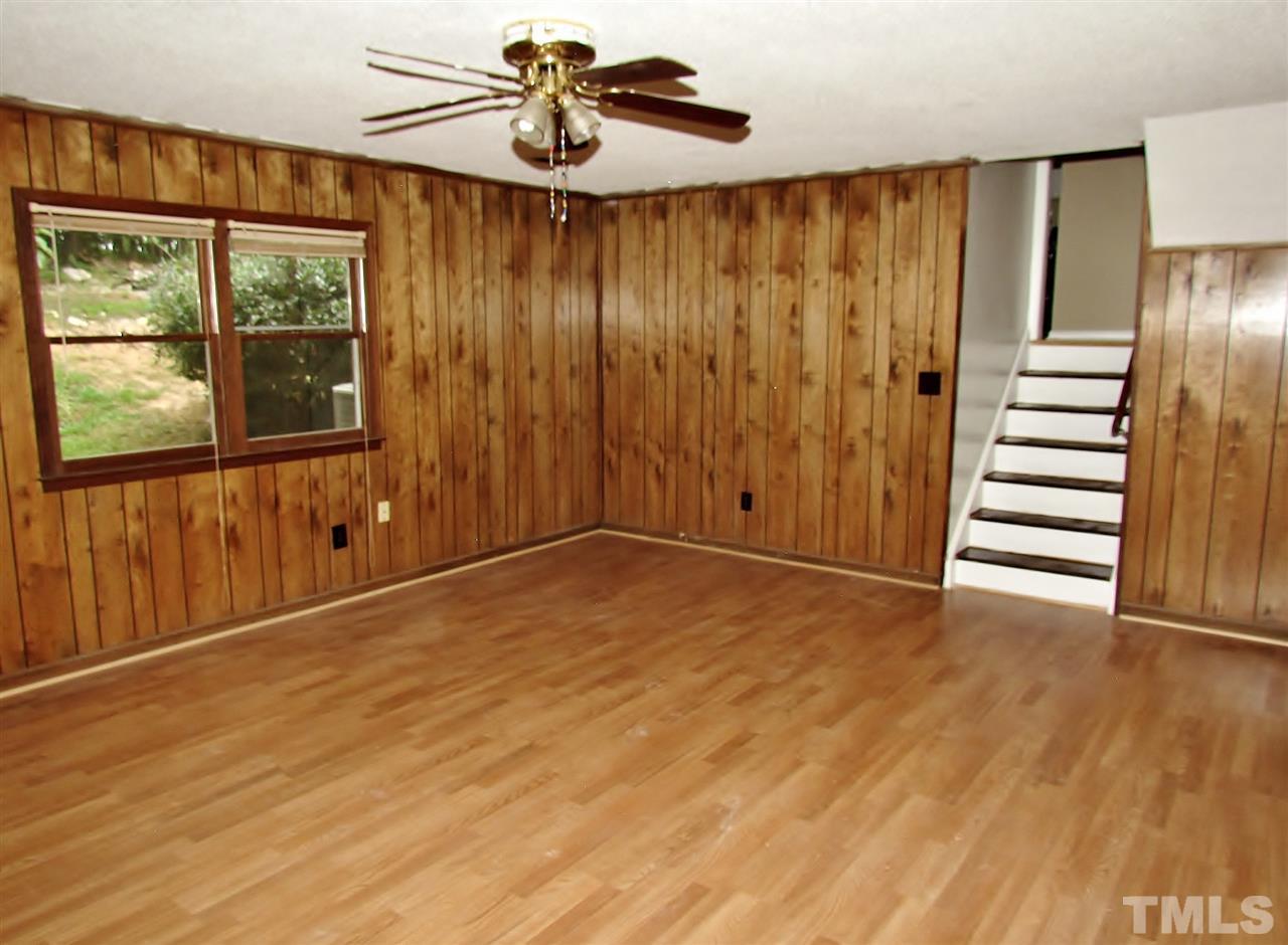 7813 Nugget Lane Raleigh, NC 27615 - Photo 16 of 25 a view of an empty room with wooden floor and a window
