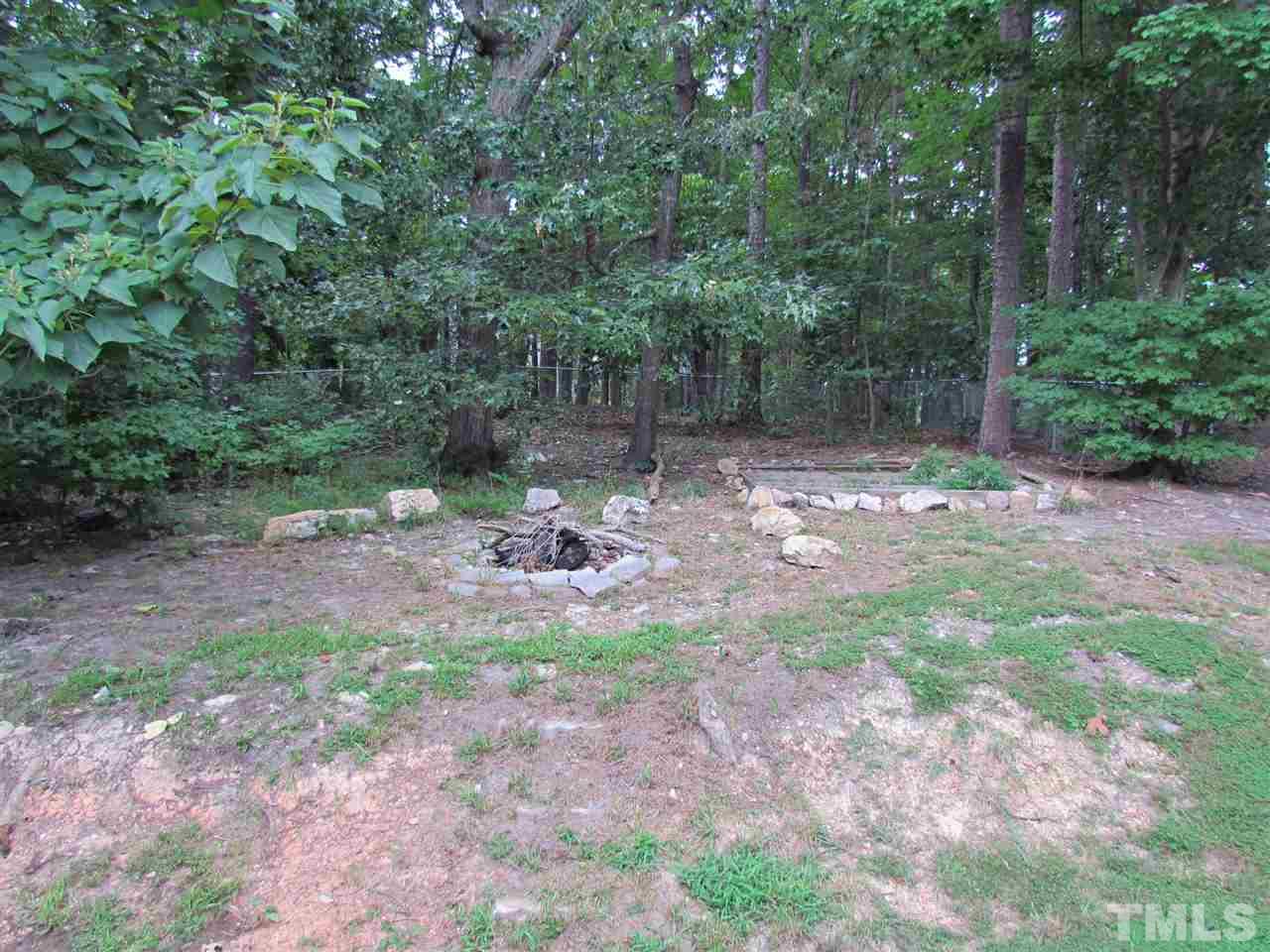 7813 Nugget Lane Raleigh, NC 27615 - Photo 21 of 25 a backyard of a house with lots of green space