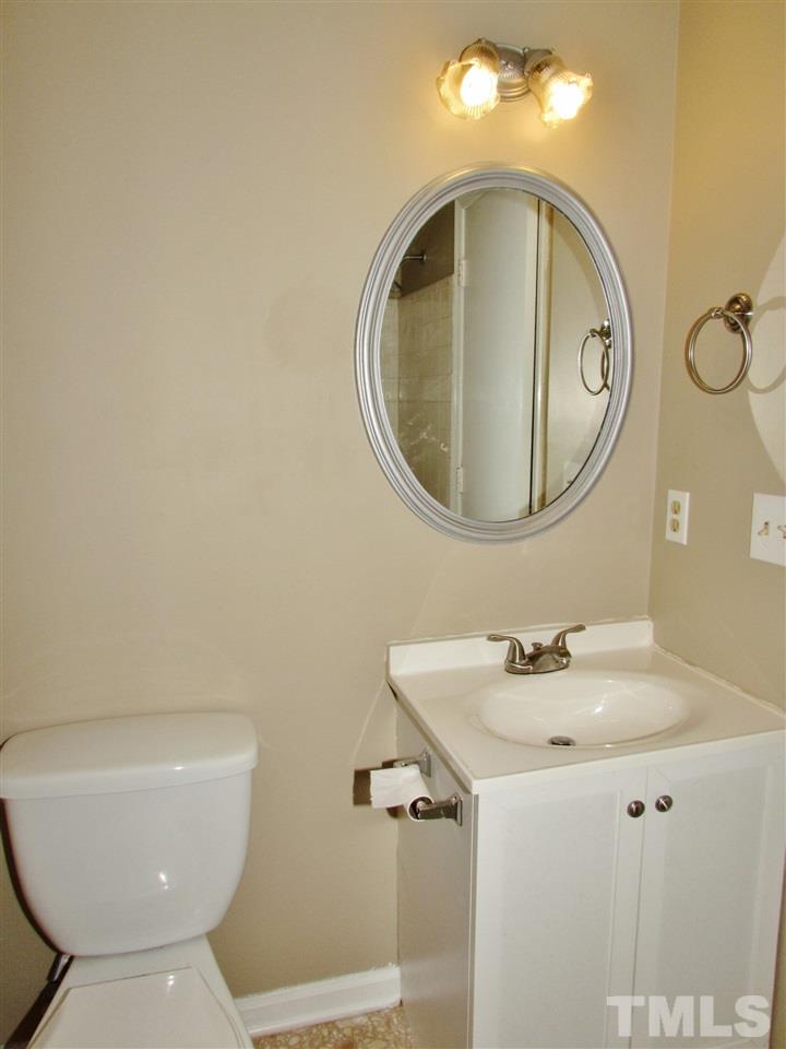 7813 Nugget Lane Raleigh, NC 27615 - Photo 10 of 25 a bathroom with a toilet sink and mirror
