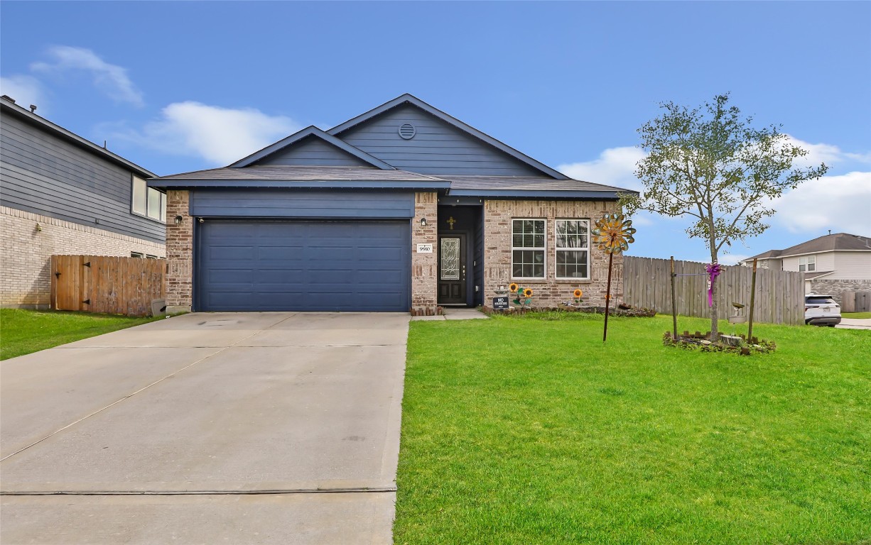 9910 Pine Forest Baytown, TX 77521 - Photo 1 of 26 a front view of a house with a yard and garage