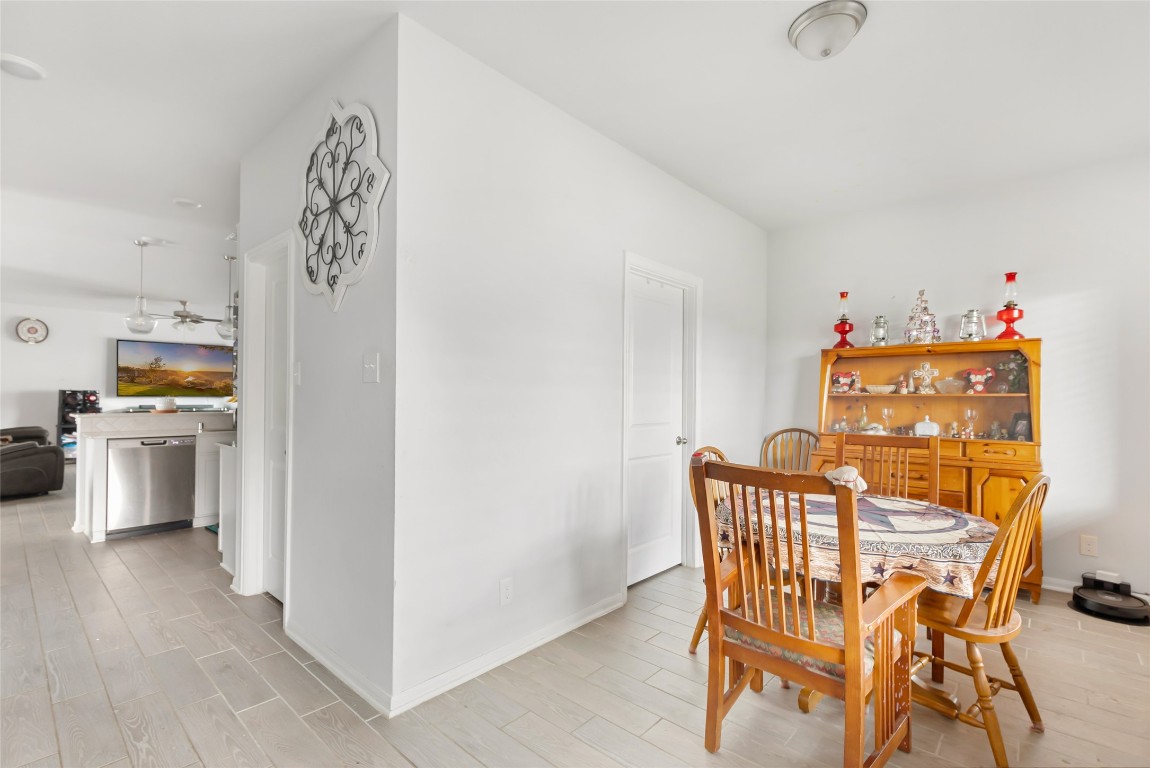 9910 Pine Forest Baytown, TX 77521 - Photo 15 of 26 a view of a dining room with furniture and wooden floor