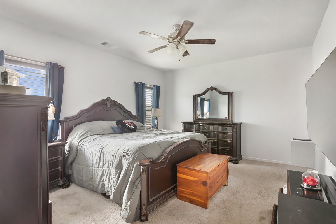 9910 Pine Forest Baytown, TX 77521 - Photo 17 of 26 a bedroom with a bed and a chandelier