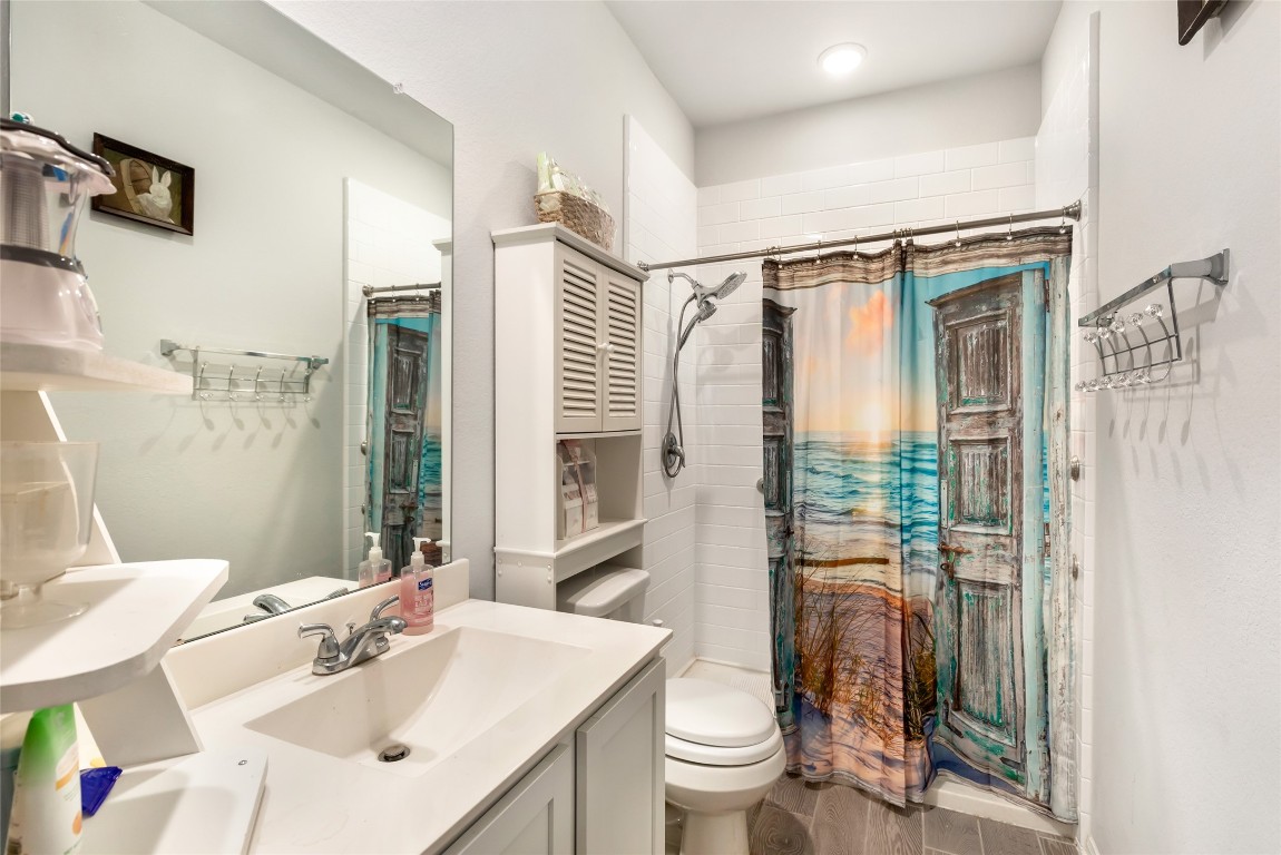 9910 Pine Forest Baytown, TX 77521 - Photo 20 of 26 a bathroom with a sink toilet and shower