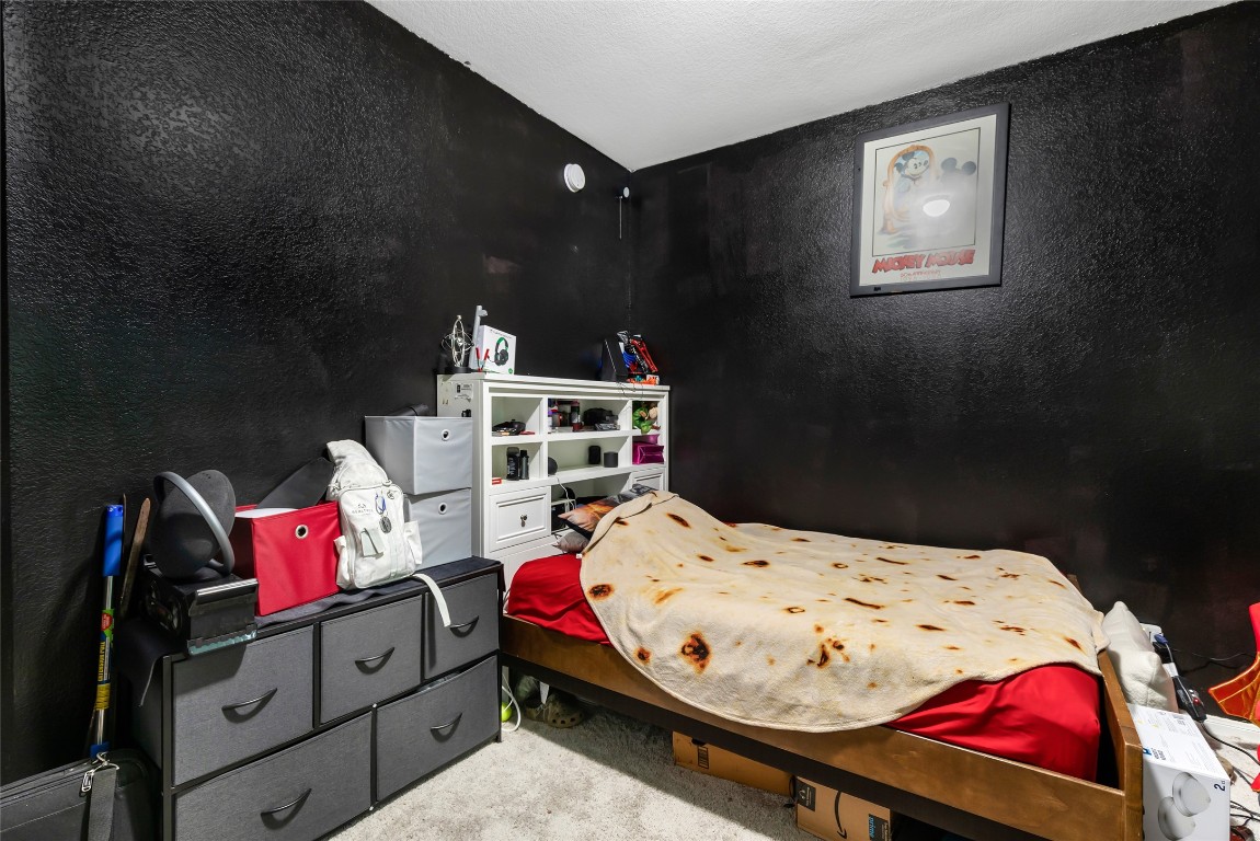 9910 Pine Forest Baytown, TX 77521 - Photo 21 of 26 a bedroom with a bed and dresser