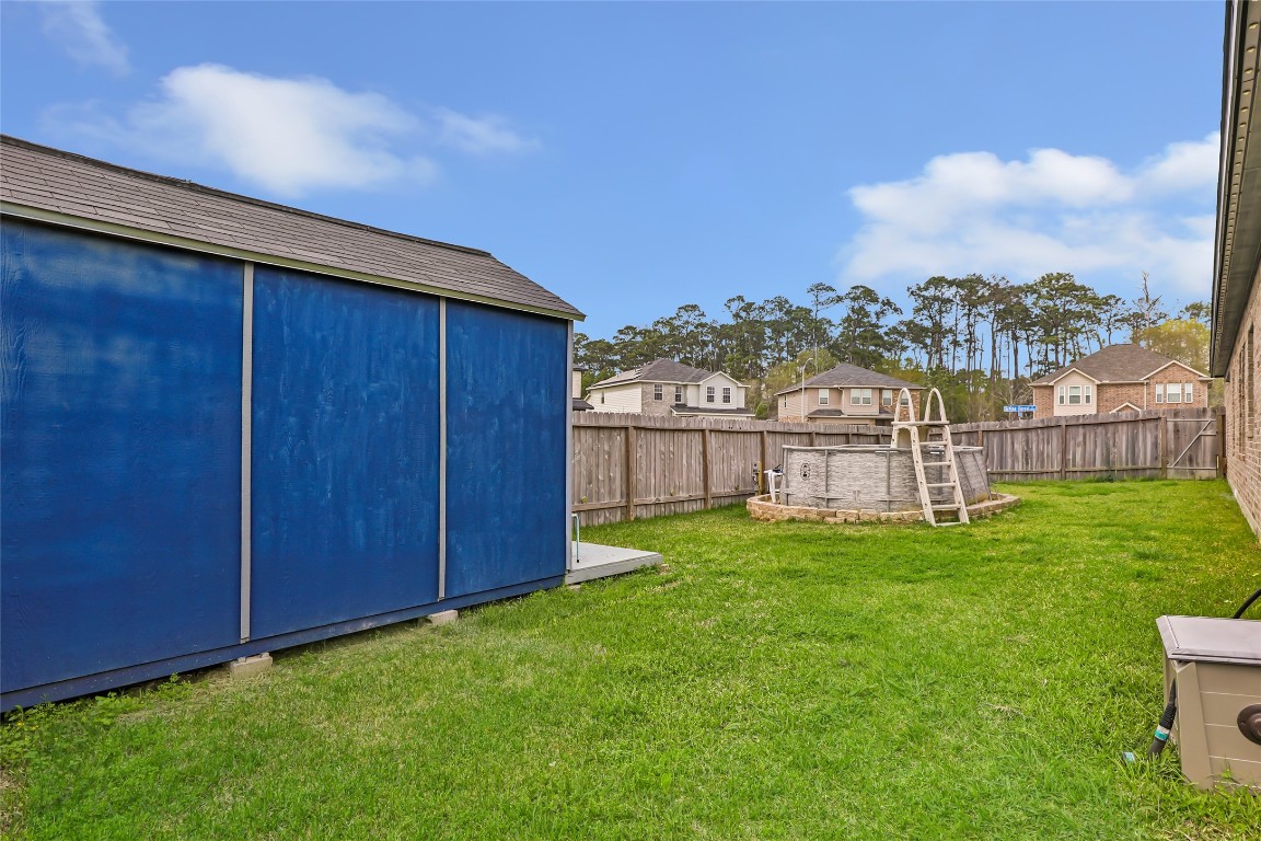 9910 Pine Forest Baytown, TX 77521 - Photo 24 of 26 a view of yard with house and wooden fence