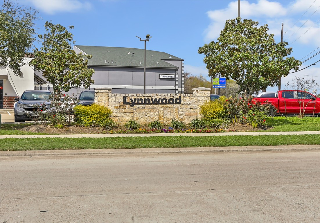 9910 Pine Forest Baytown, TX 77521 - Photo 26 of 26 a front view of a house with a yard and garage