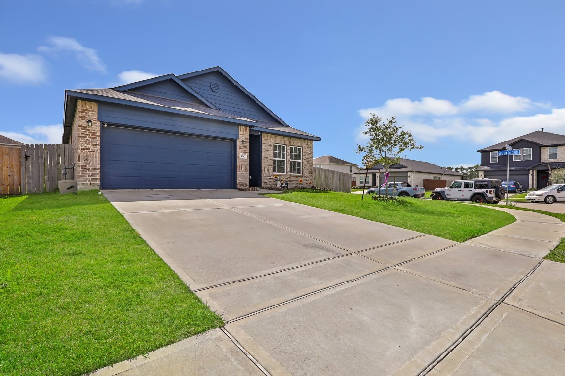 9910 Pine Forest Baytown, TX 77521 - Photo 3 of 26 a front view of a house with a yard and garage
