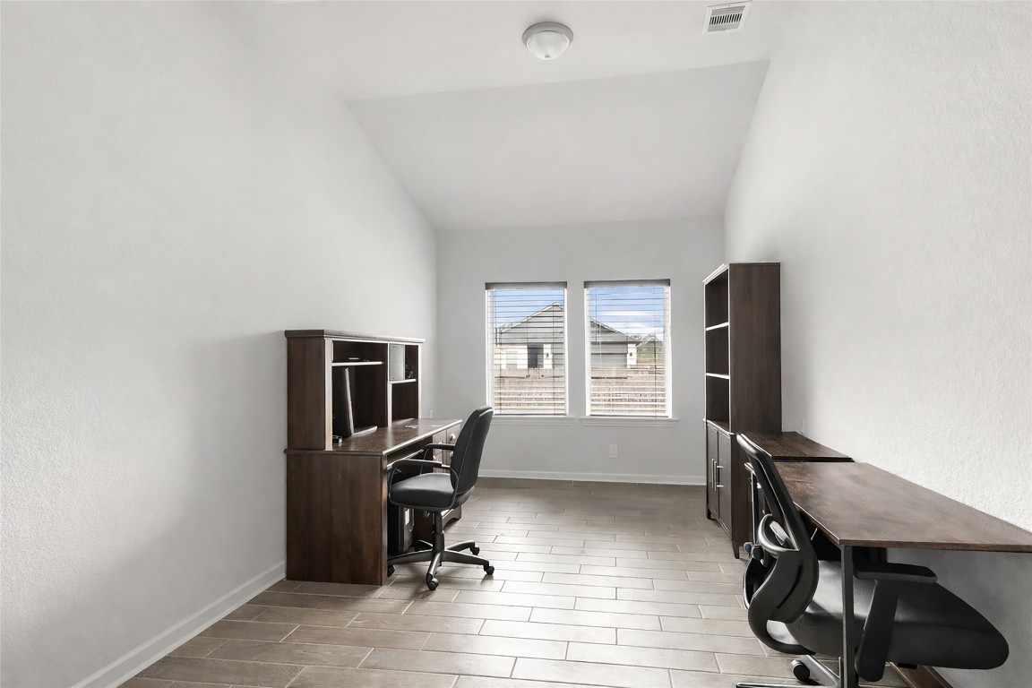 9910 Pine Forest Baytown, TX 77521 - Photo 9 of 26 a view of a workspace with furniture and a window