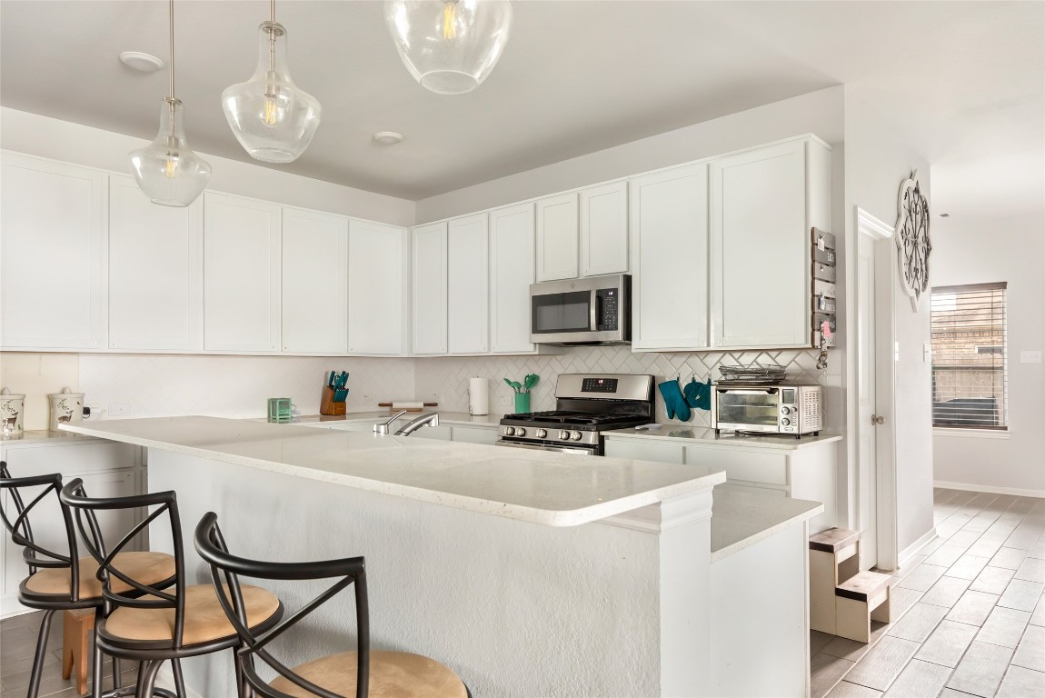 9910 Pine Forest Baytown, TX 77521 - Photo 10 of 26 a kitchen with table chairs cabinets and appliances