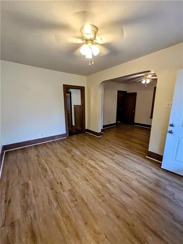 a view of an empty room and wooden floor