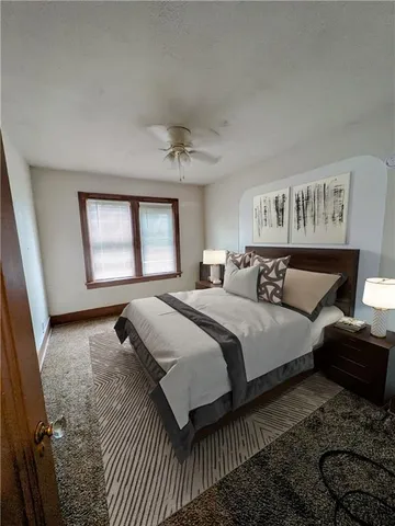 a bedroom with bed and window