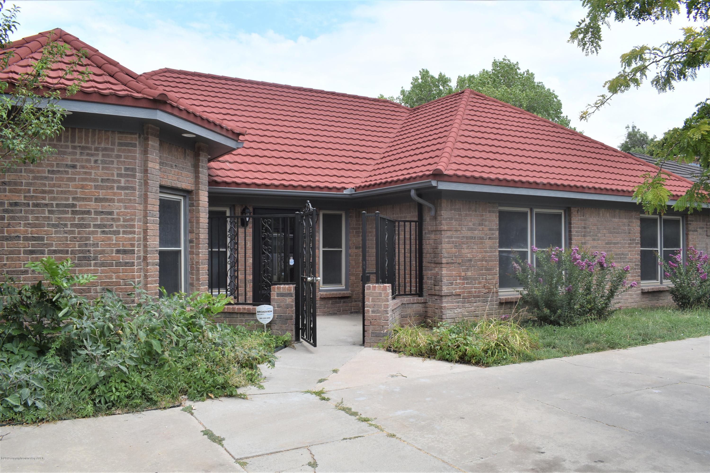 a front view of a house with garden and porch