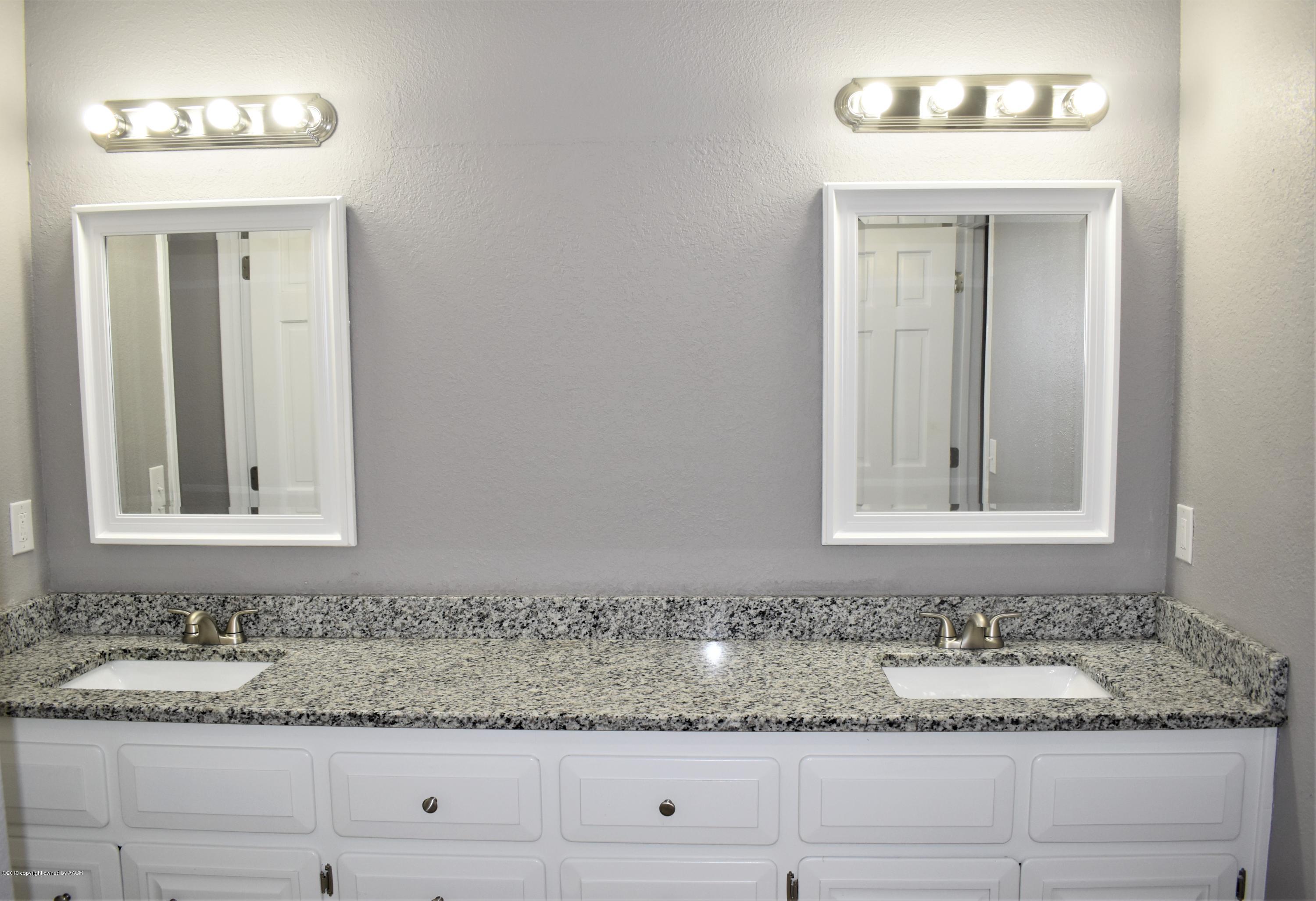 7516 Tripp Avenue Amarillo, TX 79121 - Photo 15 of 33 a bathroom with a sink and a mirror