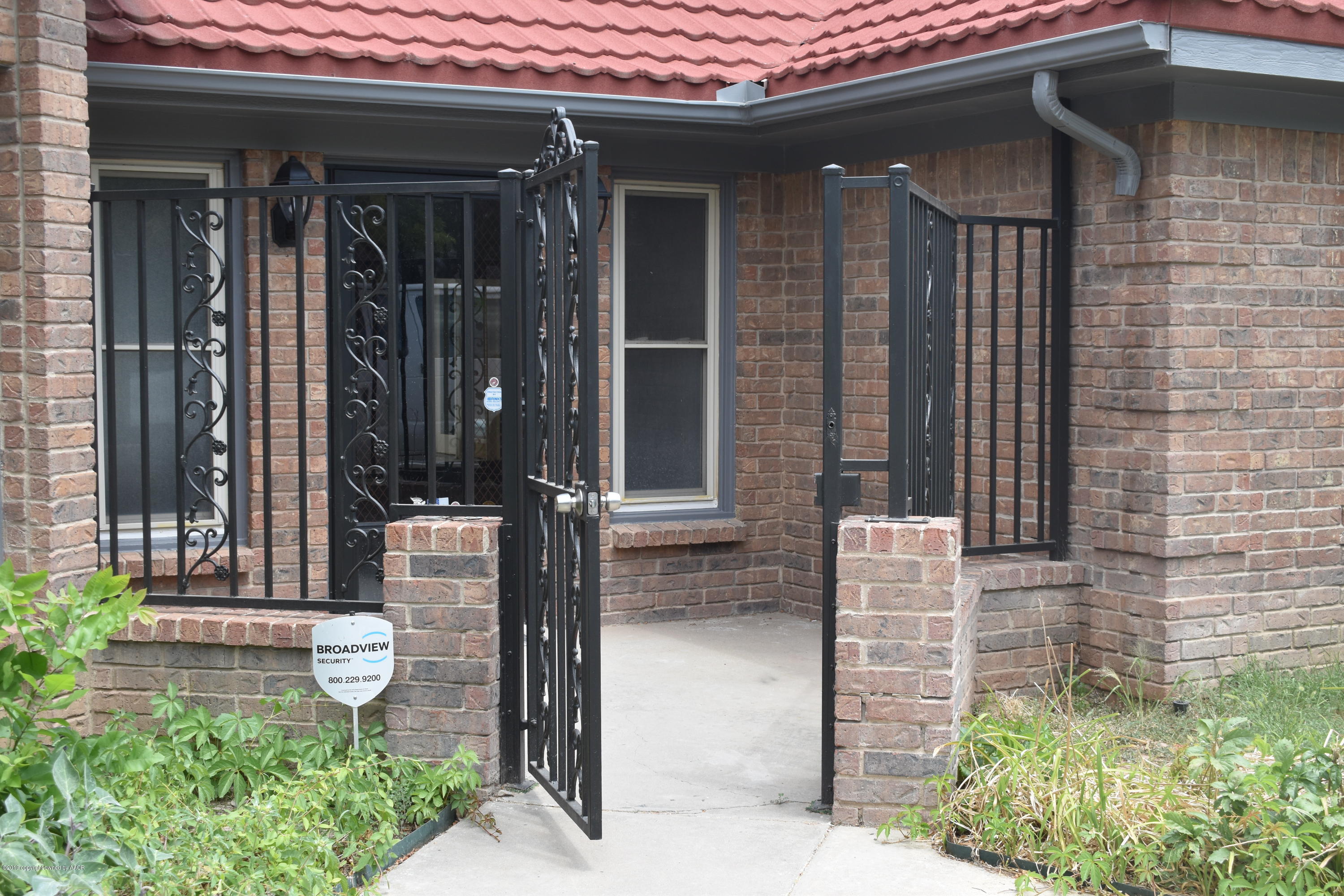 7516 Tripp Avenue Amarillo, TX 79121 - Photo 3 of 33 a front view of a house with a garden