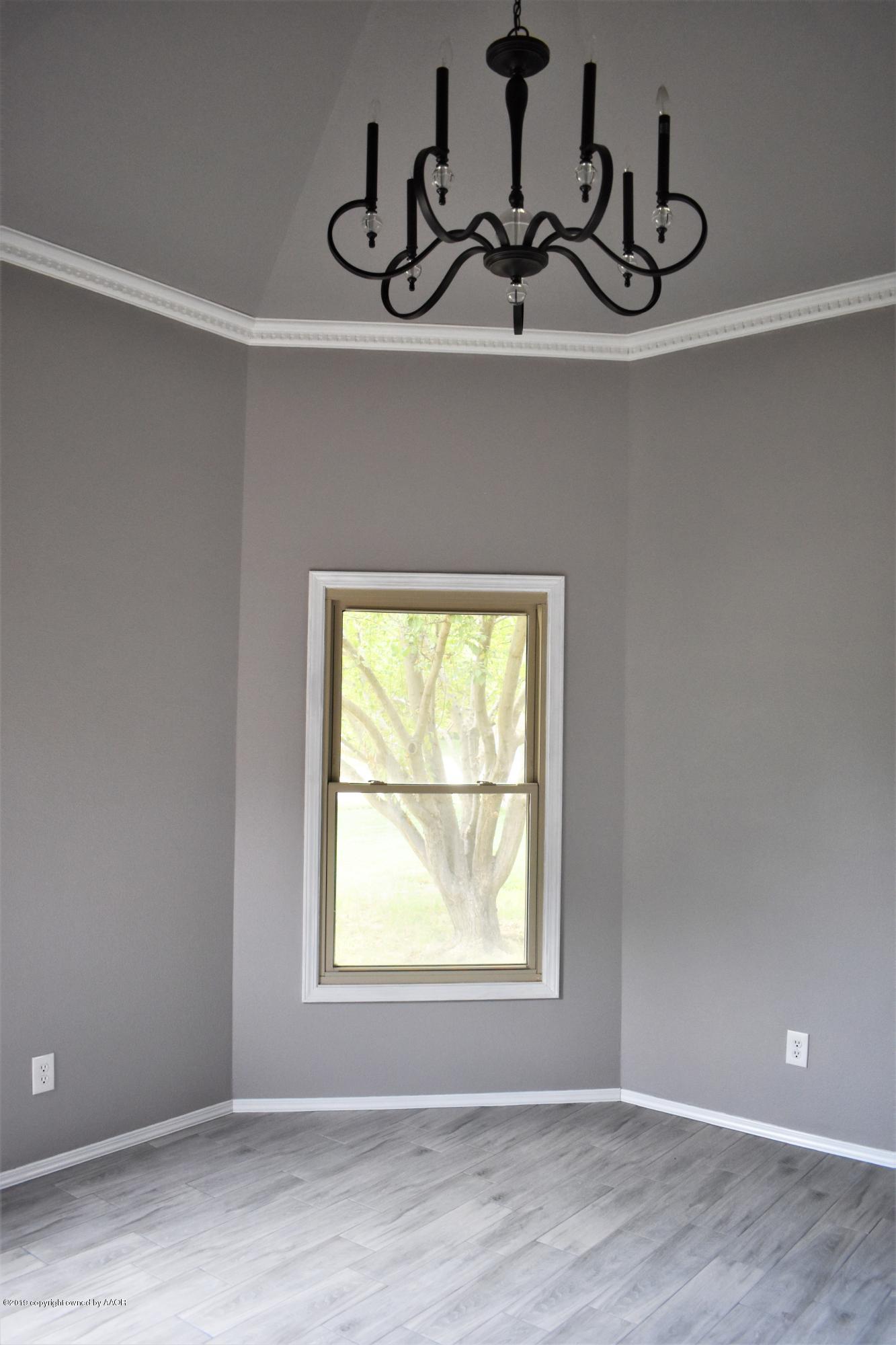 7516 Tripp Avenue Amarillo, TX 79121 - Photo 5 of 33 a view of a room with rack on the wall and a window