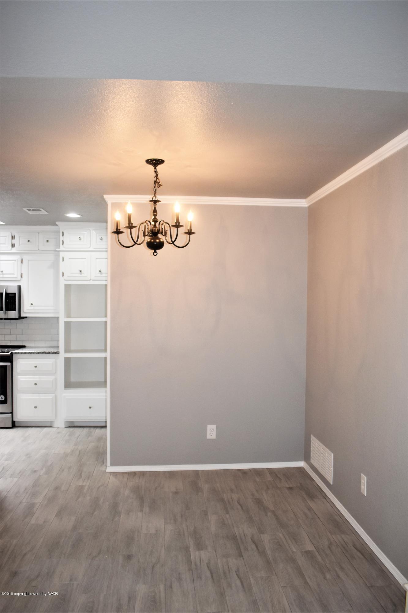 7516 Tripp Avenue Amarillo, TX 79121 - Photo 6 of 33 wooden floor in an empty room