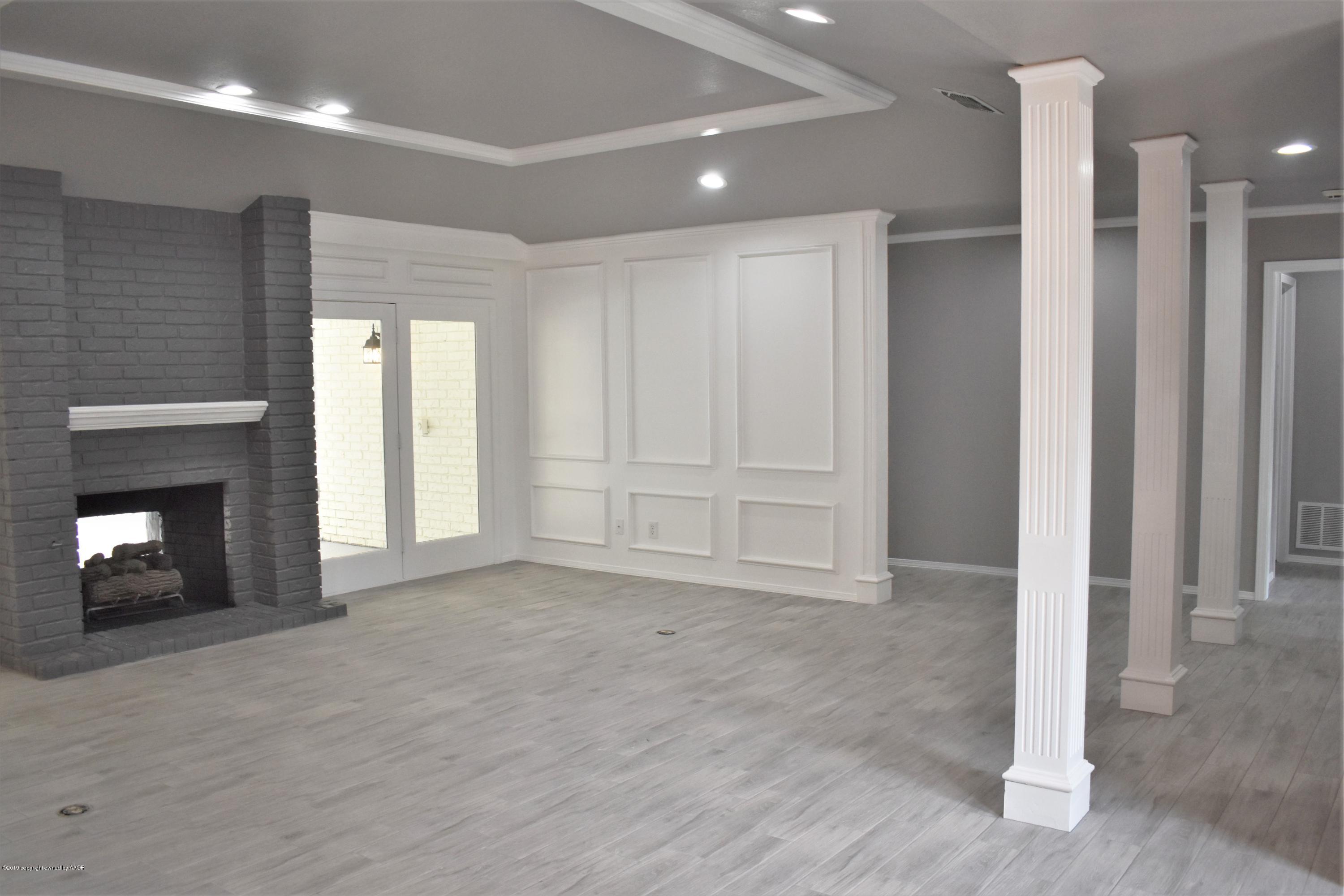 7516 Tripp Avenue Amarillo, TX 79121 - Photo 9 of 33 a view of an empty room with a fireplace and a window