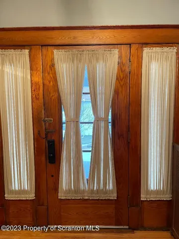 a bedroom with a bed and painting on the wall