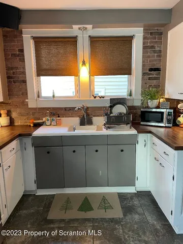 a kitchen with a sink a window and cabinets