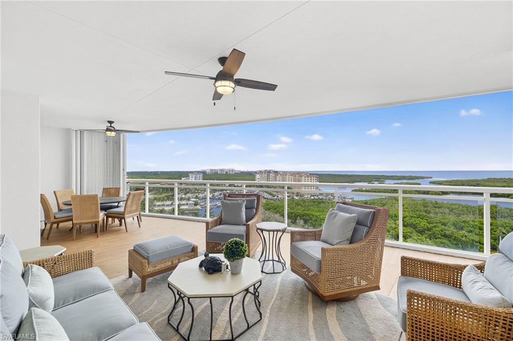 13915 Old Coast Road, Unit 1503 Naples, FL 34110 - Photo 1 of 49 a living room with furniture and a floor to ceiling window