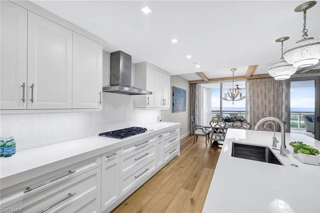 a large white kitchen with cabinets