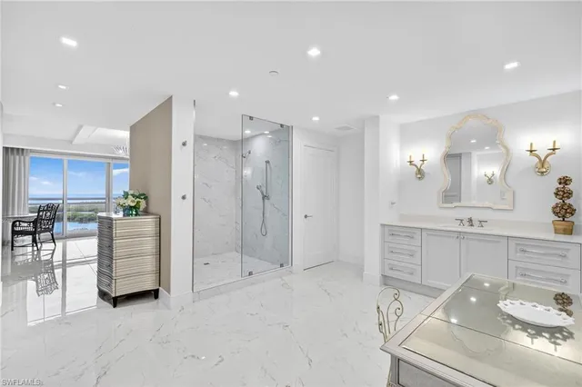 a large white kitchen with white cabinets and stainless steel appliances