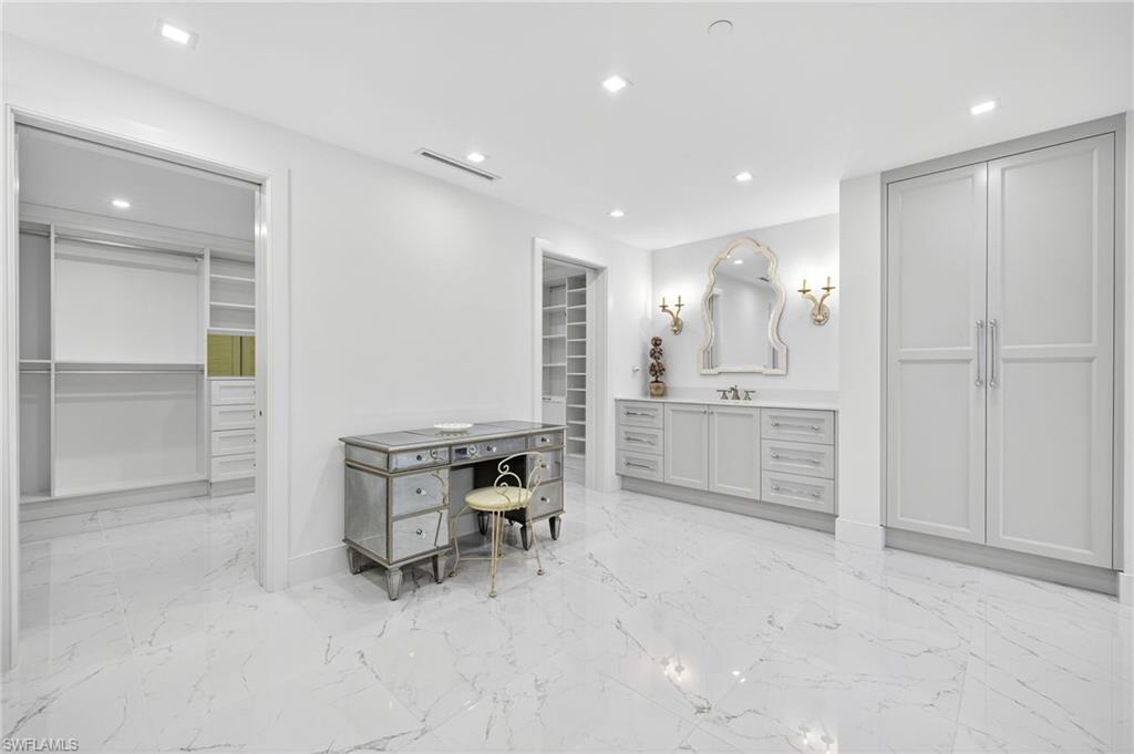 13915 Old Coast Road, Unit 1503 Naples, FL 34110 - Photo 17 of 49 a kitchen with a sink cabinets and outdoor space