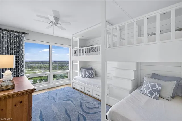 a bedroom with furniture and a large window