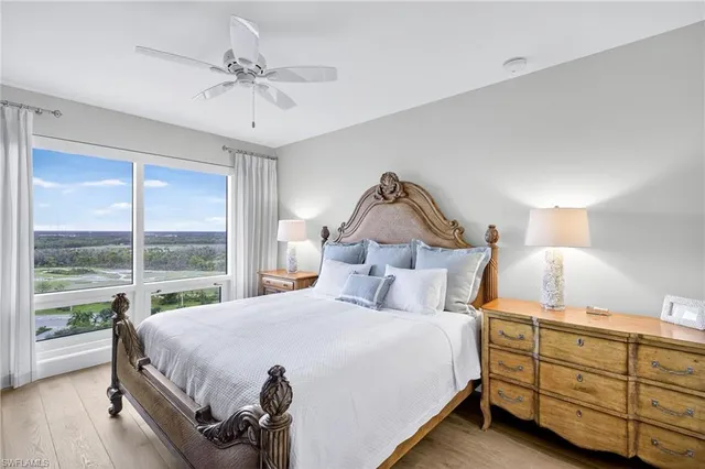 a bedroom with a bed and a large window