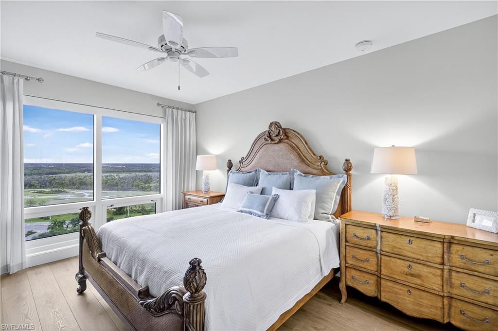 13915 Old Coast Road, Unit 1503 Naples, FL 34110 - Photo 21 of 49 a bedroom with a bed and a large window