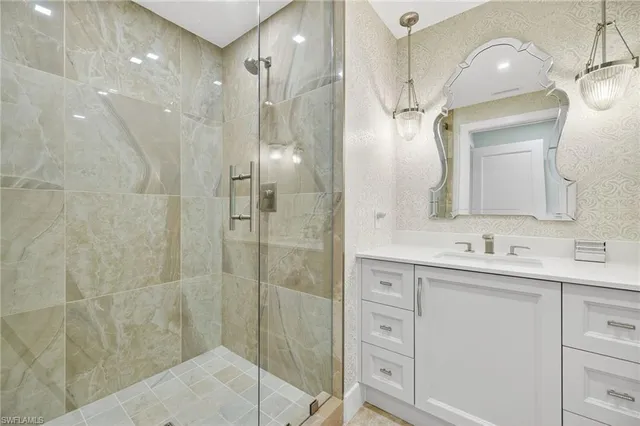 a bathroom with a double vanity sink mirror and shower