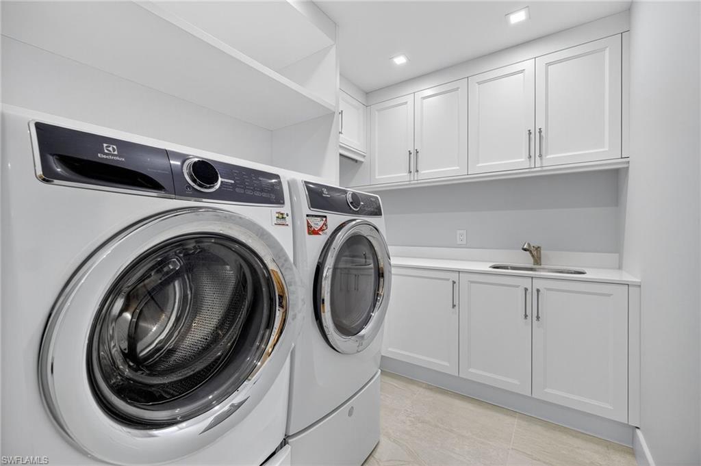 13915 Old Coast Road, Unit 1503 Naples, FL 34110 - Photo 25 of 49 a utility room with sink dryer and washer