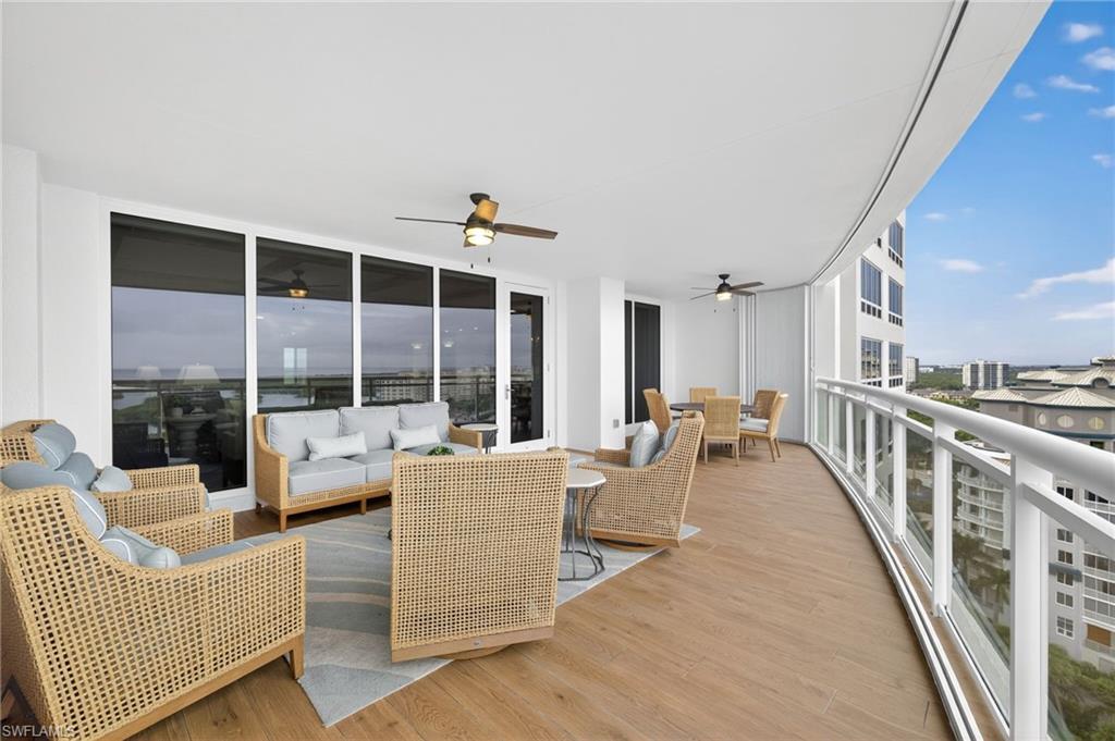 13915 Old Coast Road, Unit 1503 Naples, FL 34110 - Photo 28 of 49 a living room with furniture floor to ceiling window and potted plants