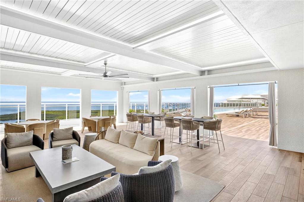13915 Old Coast Road, Unit 1503 Naples, FL 34110 - Photo 34 of 49 a living room with furniture and a large window