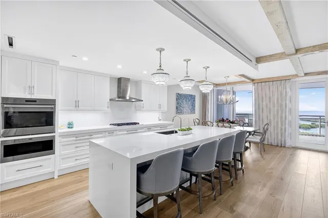 a large kitchen with kitchen island a dining table and chairs