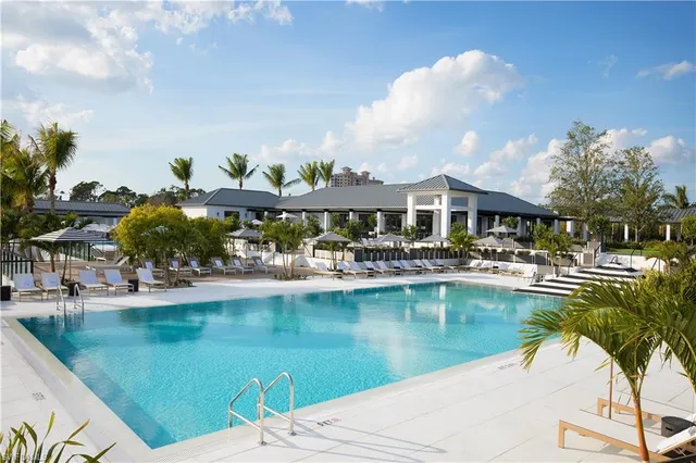a view of swimming pool with outdoor seating and garden