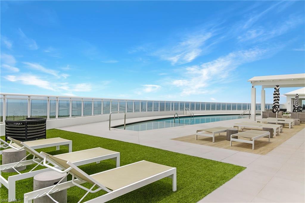 13915 Old Coast Road, Unit 1503 Naples, FL 34110 - Photo 6 of 49 a view of a swimming pool with lounge chairs