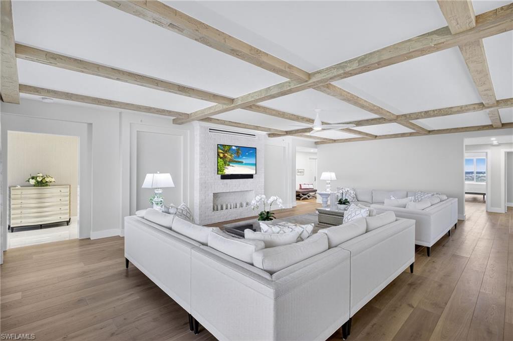 13915 Old Coast Road, Unit 1503 Naples, FL 34110 - Photo 6 of 49 a living room with furniture and a wooden floor