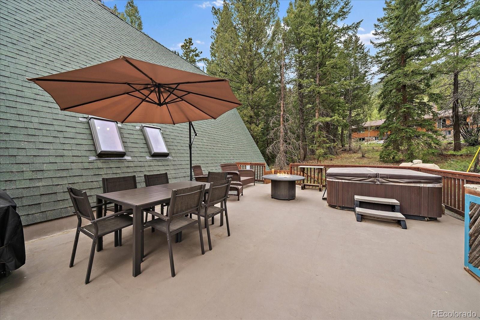 307 Snyder Mountain Road Evergreen, CO 80439 - Photo 4 of 41 an outdoor space with patio and white umbrellas