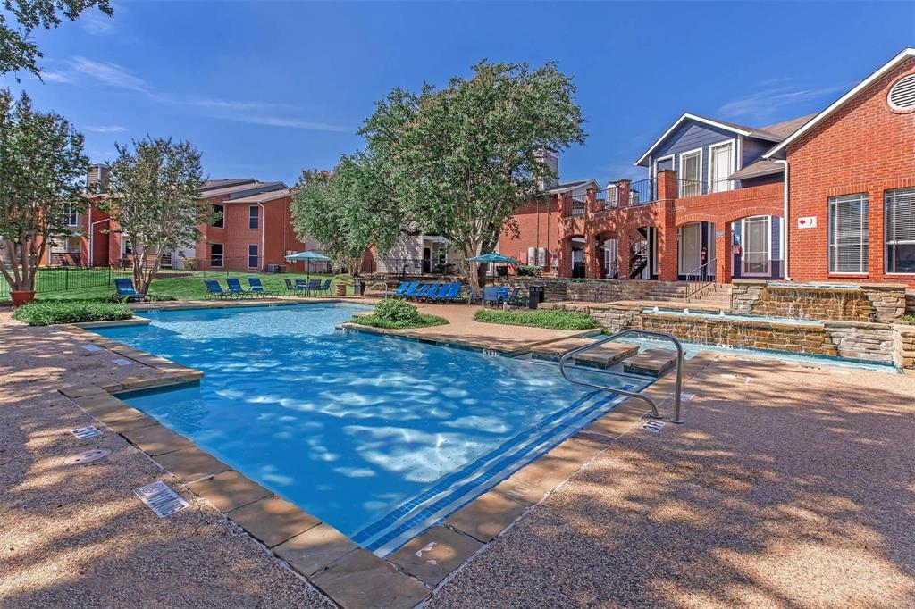 1826 Esters Road, Unit 1050 Irving, TX 75061 - Photo 39 of 39 Outdoor swimming pool featuring a waterfall, integrated steps, and surrounding paved decking