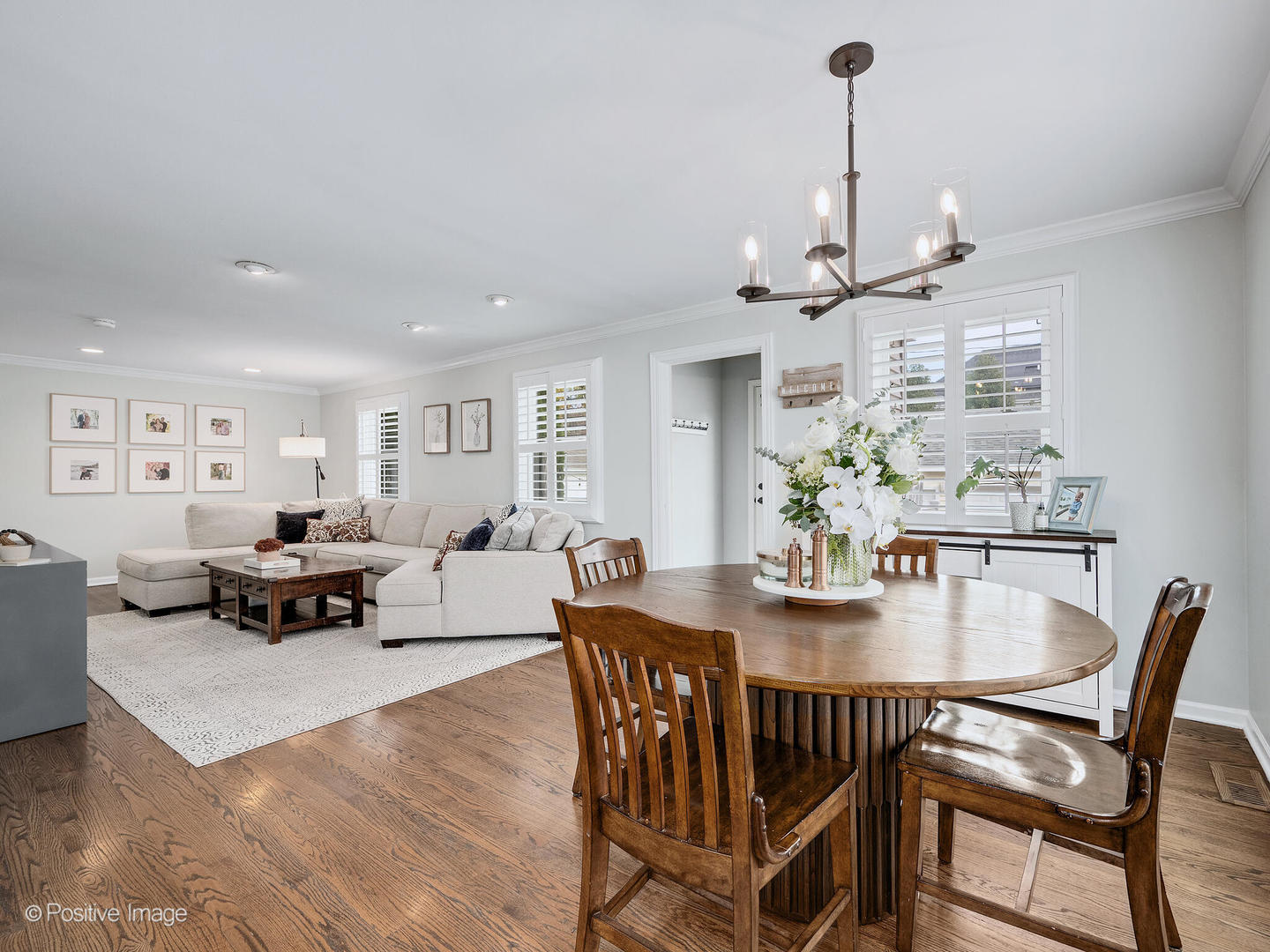 637 South Prospect Avenue Elmhurst, IL 60126 - Photo 16 of 37 a view of a dining room and livingroom with furniture wooden floor a chandelier