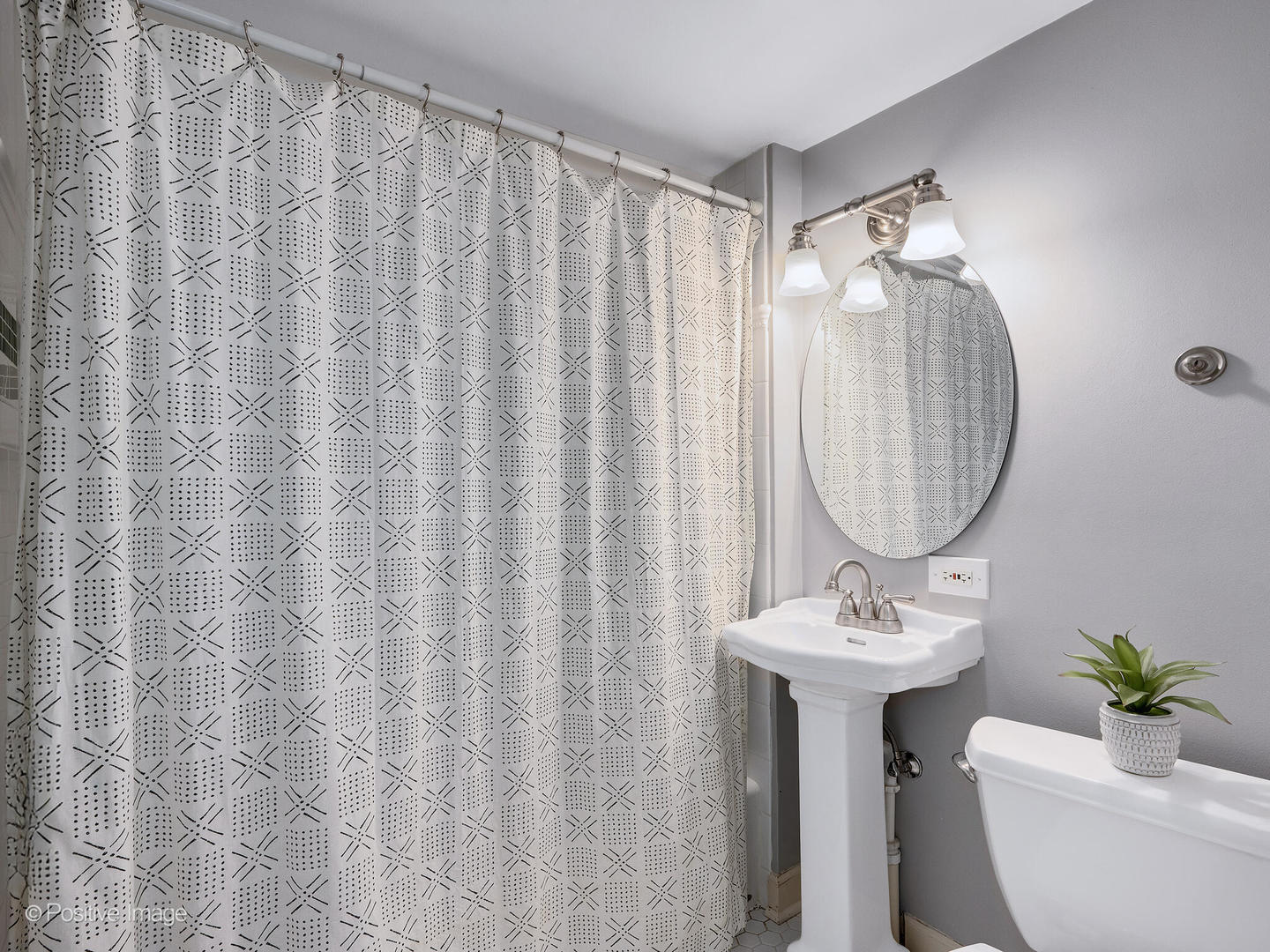 637 South Prospect Avenue Elmhurst, IL 60126 - Photo 29 of 37 a bathroom with a sink a mirror and a shower curtain