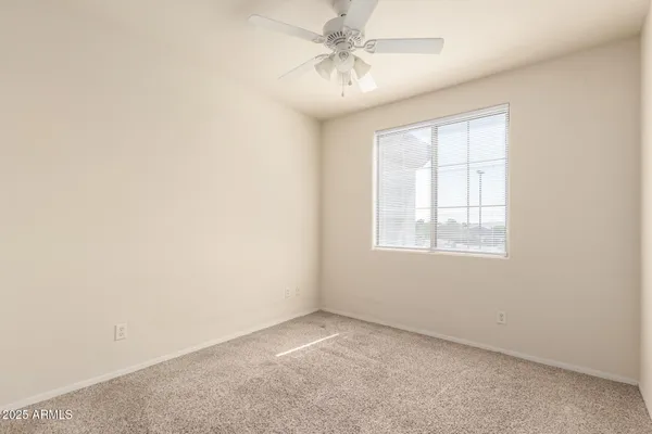 an empty room with a ceiling fan